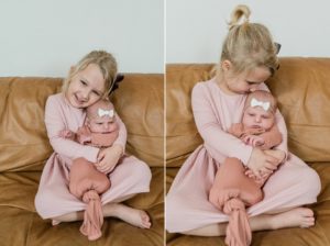 big sister holds baby during Franklin TN newborn portraits at home