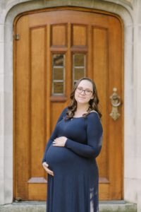 Vanderbilt University maternity portraits by wooden door with mom in blue gown