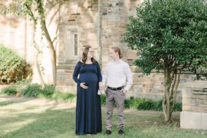 expecting couple laugh together during Nashville maternity photos