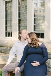 husband kisses expecting wife during TN maternity photos at Vanderbilt University