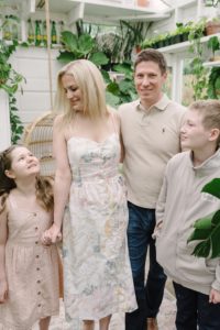 family of four poses inside East Nashville Greenhouse