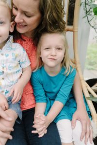 toddler makes funny face during TN family photos in East Nashville Greenhouse