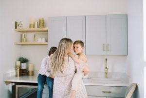 mom holds son during family photos in Murfreesboro TN kitchen