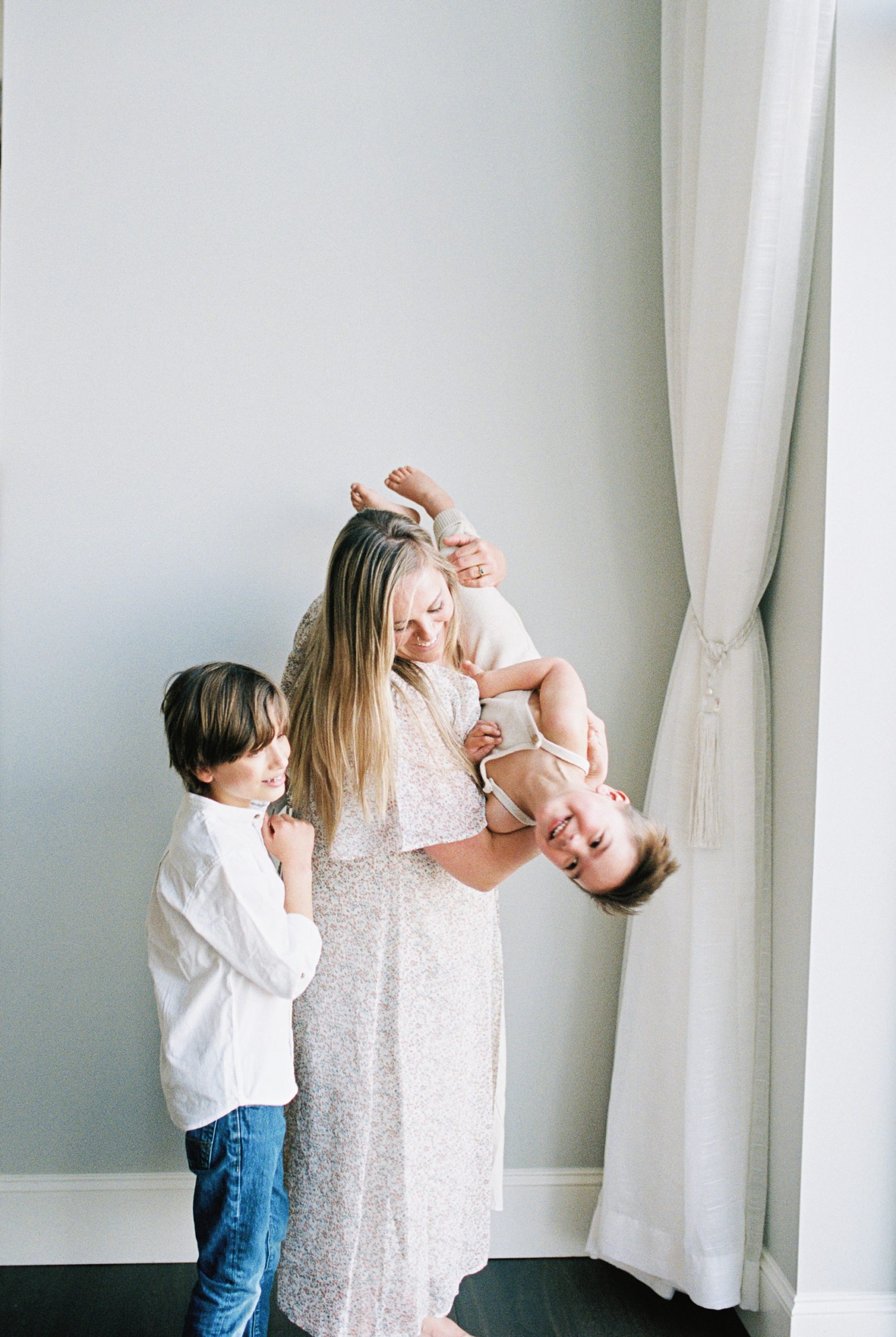 mom lifts son upside down during TN family photos