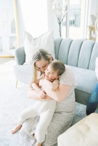 mom snuggles with son during family photos in Murfreesboro living room
