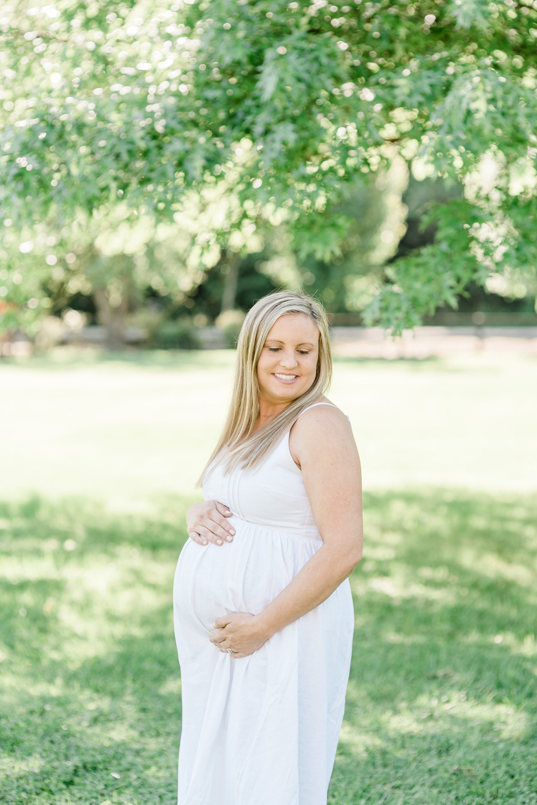 mom holds baby belly during Nashville maternity photos