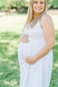 mom holds baby belly during Nashville maternity portraits