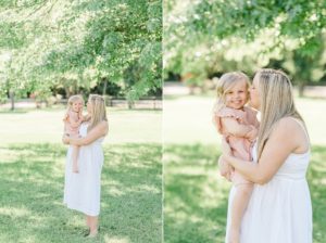 mom and toddler pose in backyard during spring maternity photos