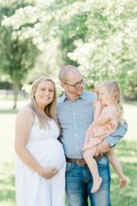 expecting mom holds belly during Nashville maternity portraits