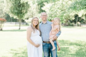 family of three holds belly during Nashville maternity portraits