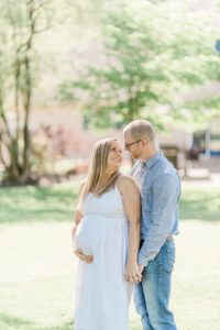 husband and wife hold hands during Nashville maternity portraits