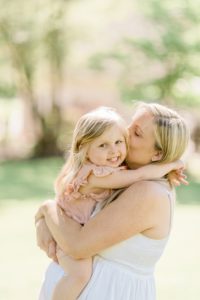 mom kisses toddler's cheek during Nashville maternity portraits