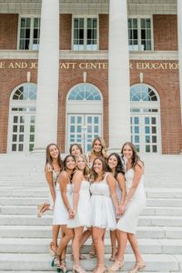 group of 8 seniors poses on steps at Vanderbilt University