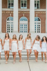8 girlfriends walk along steps at Vanderbilt University