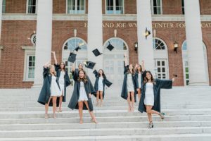seniors throw caps in the air during Vanderbilt University graduate portraits