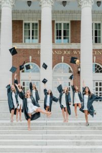 seniors toss caps in the air during Vanderbilt University graduate portraits