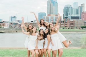 girls pose with downtown Nashville in background