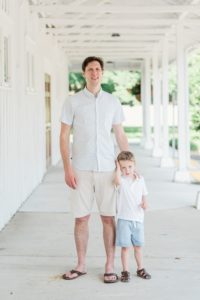 dad and son stand together on front porch during Nashville family photos