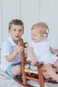 one year old and big brother sit together on porch during Nashville first birthday portraits