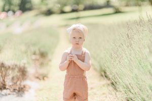 daughter in tan jumper laughs during lavender field mini sessions