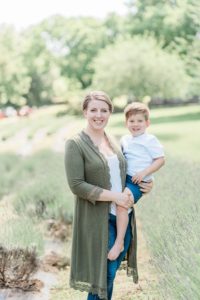 mom holds son on hip during TN family photos in lavender field