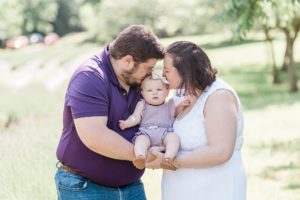 parents kiss baby during Lavender Field Mini Sessions