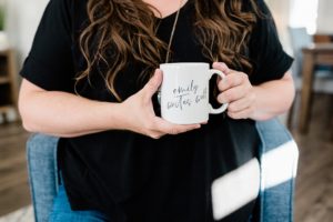 copywriter holds coffee mug in black shirt during Nashville branding session
