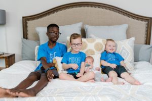 big brothers hold baby during Nashville lifestyle newborn session