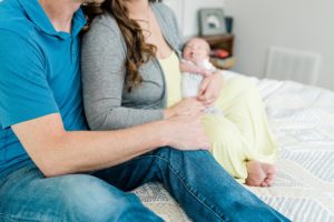 mom and dad hold baby boy during Nashville lifestyle newborn session