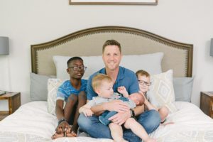 dad holds four sons during Nashville lifestyle newborn session