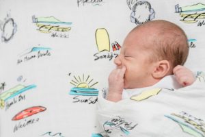 baby boy lays on surfing sheets during Nashville lifestyle newborn session