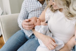 parents look at baby boy during Nashville Newborn Portraits