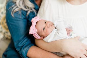 baby girl held by mother and grandmother during TN newborn photos