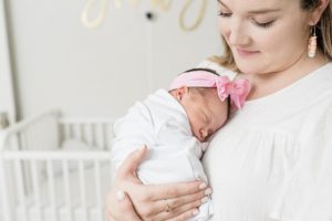 mom holds daughter on chest during newborn photos in TN