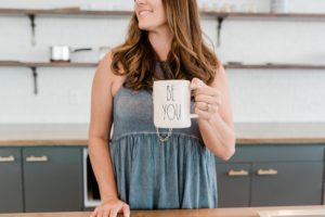 woman shows off custom coffee mug during branding photos