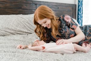 mom looks down at baby girl during Franklin TN newborn session