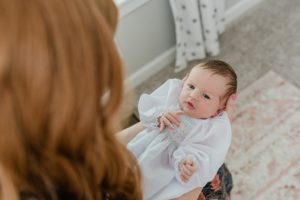 mom looks at baby girl during newborn photos in Franklin TN