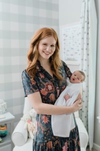 mom rocks baby girl during newborn photos