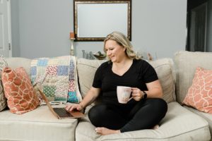 photographer works on couch during Nashville Personal Branding Session