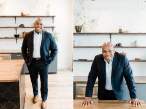 man poses in kitchen during branding photos