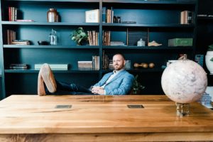 man sits at desk with feet up during Nashville team branding portraits