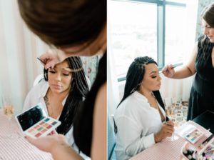 woman applies makeup for client during branding session