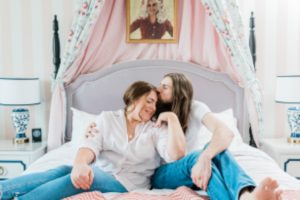 couple sits on pink bed at the Nashville Graduate Hotel
