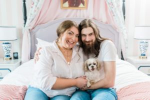 woman poses with husband and dog at the Nashville Graduate Hotel