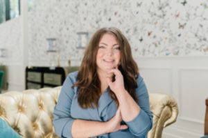 woman sits on gold couch during Nashville Graduate Hotel branding session