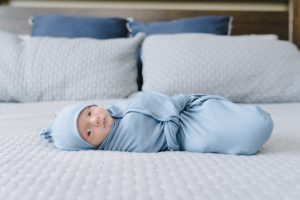 baby lays in blue wrap during Lifestyle Newborn Session in Nashville