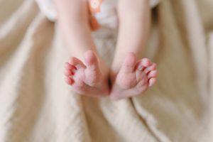 baby's feet on blanket during newborn photos at home
