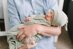 baby in green wrap sleeps during Lifestyle Newborn Session in Nashville