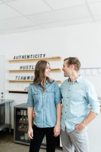 husband and wife smile at each other during Nashville branding photography session