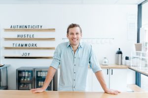 man leans on counter in bakery